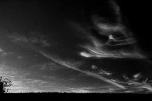 black and white photo of sky with some clouds
