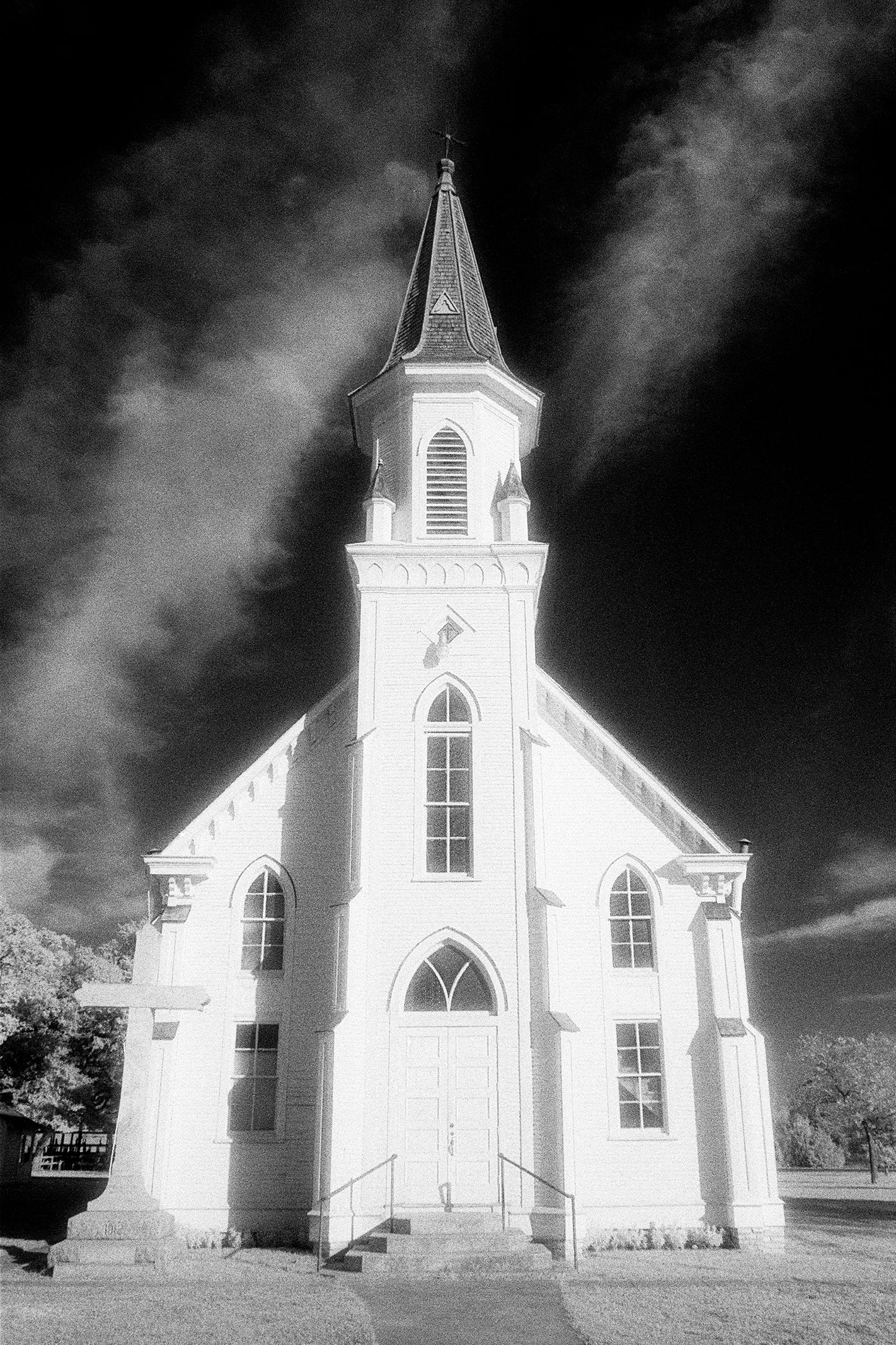 black and white photo of old church with steeple