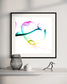 abstract heart in pink, green, gold, teal, red on white background in black frame on light gray wall