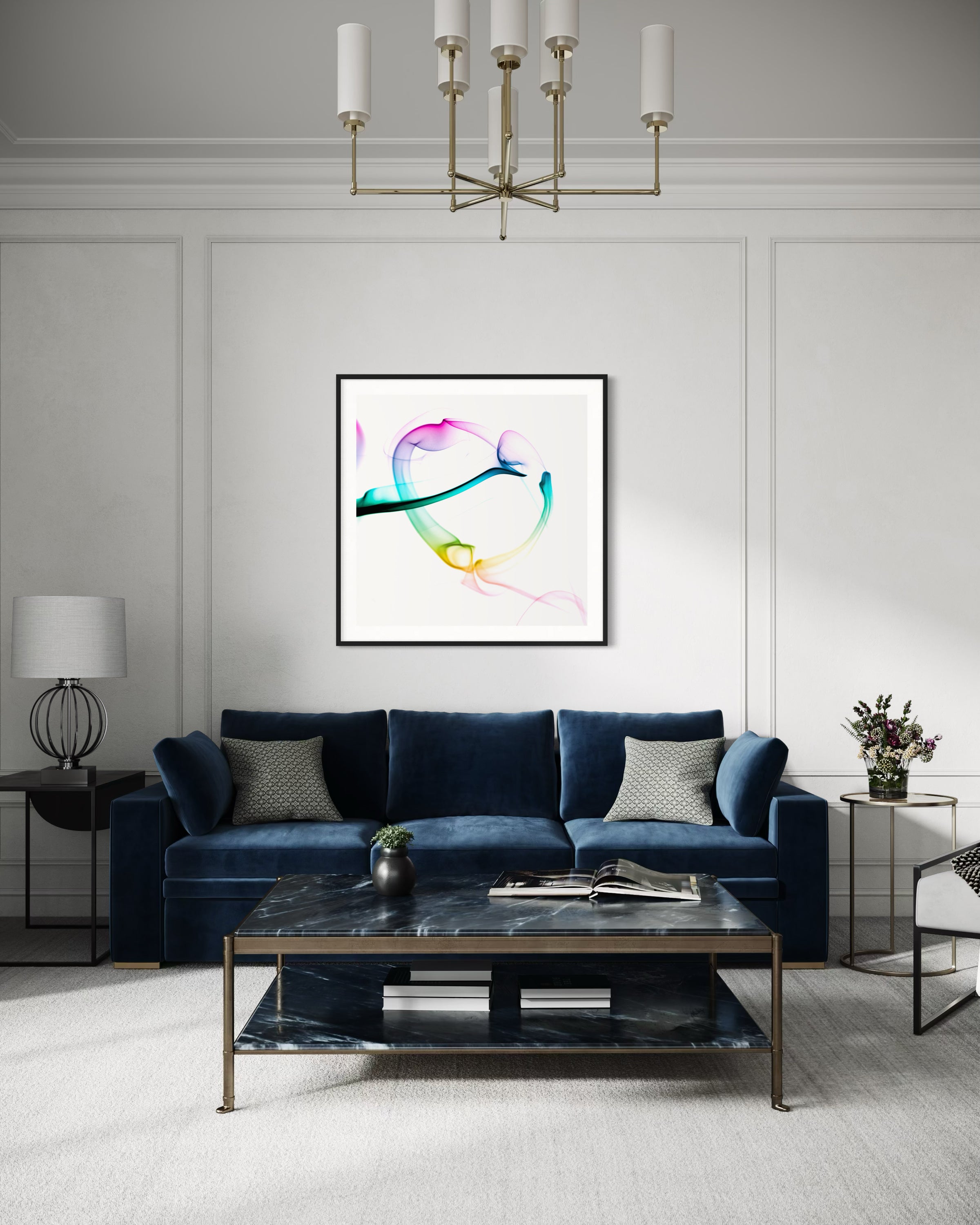 abstract heart in pink, green, gold, teal, red on white background in black frame with white matte on light gray wall with blue sofa in modern living room