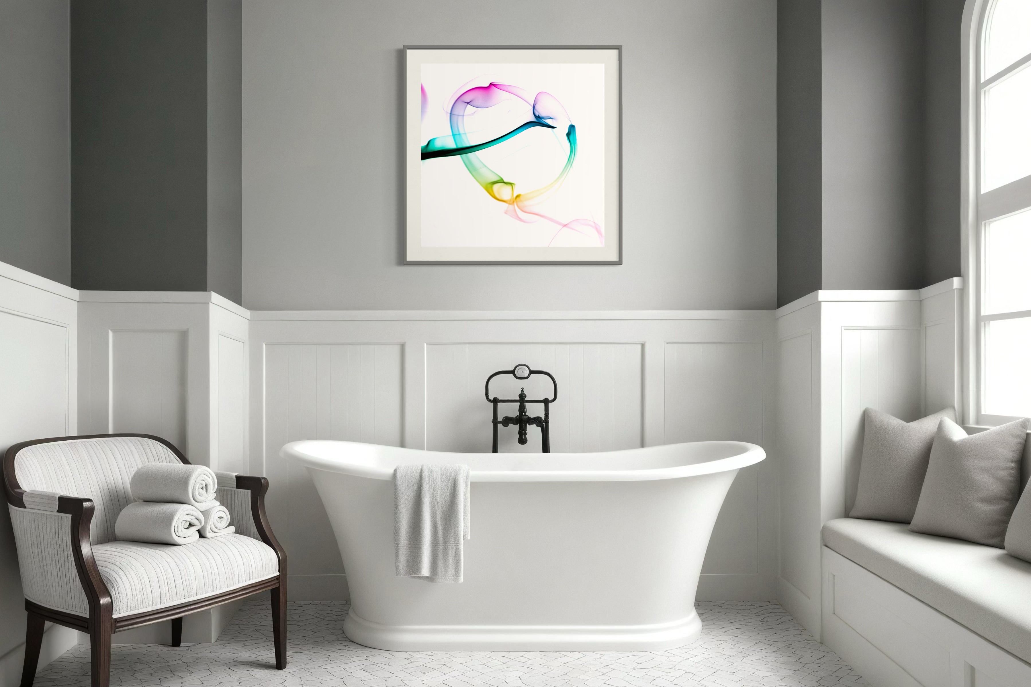 abstract heart in pink, green, gold, teal, red on white background in dark gray frame with light gray matte on light gray wall above free standing bathtub in bathroom with white and gray tones