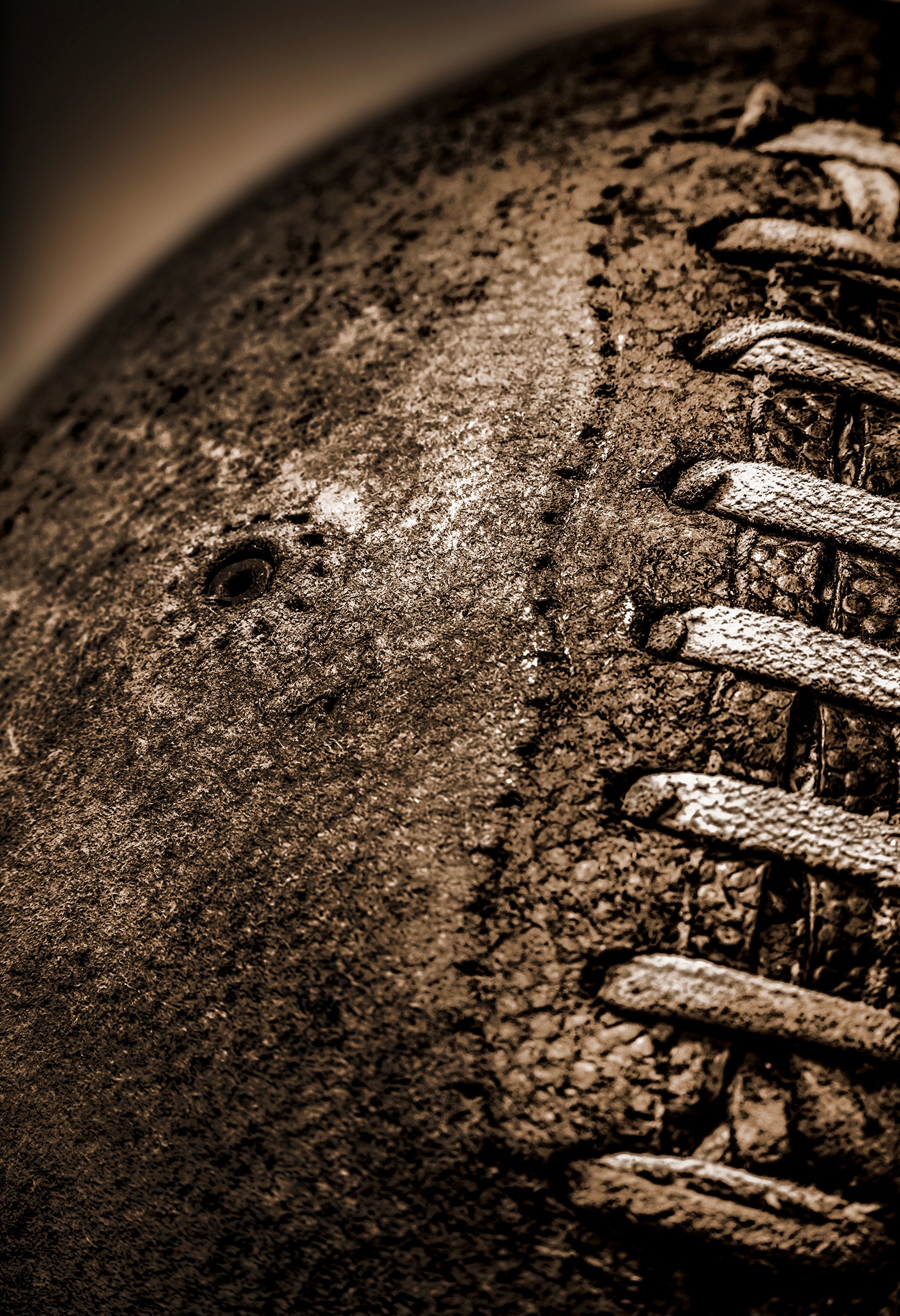 Sepia tone old football close up with a grungy look shot in studio
