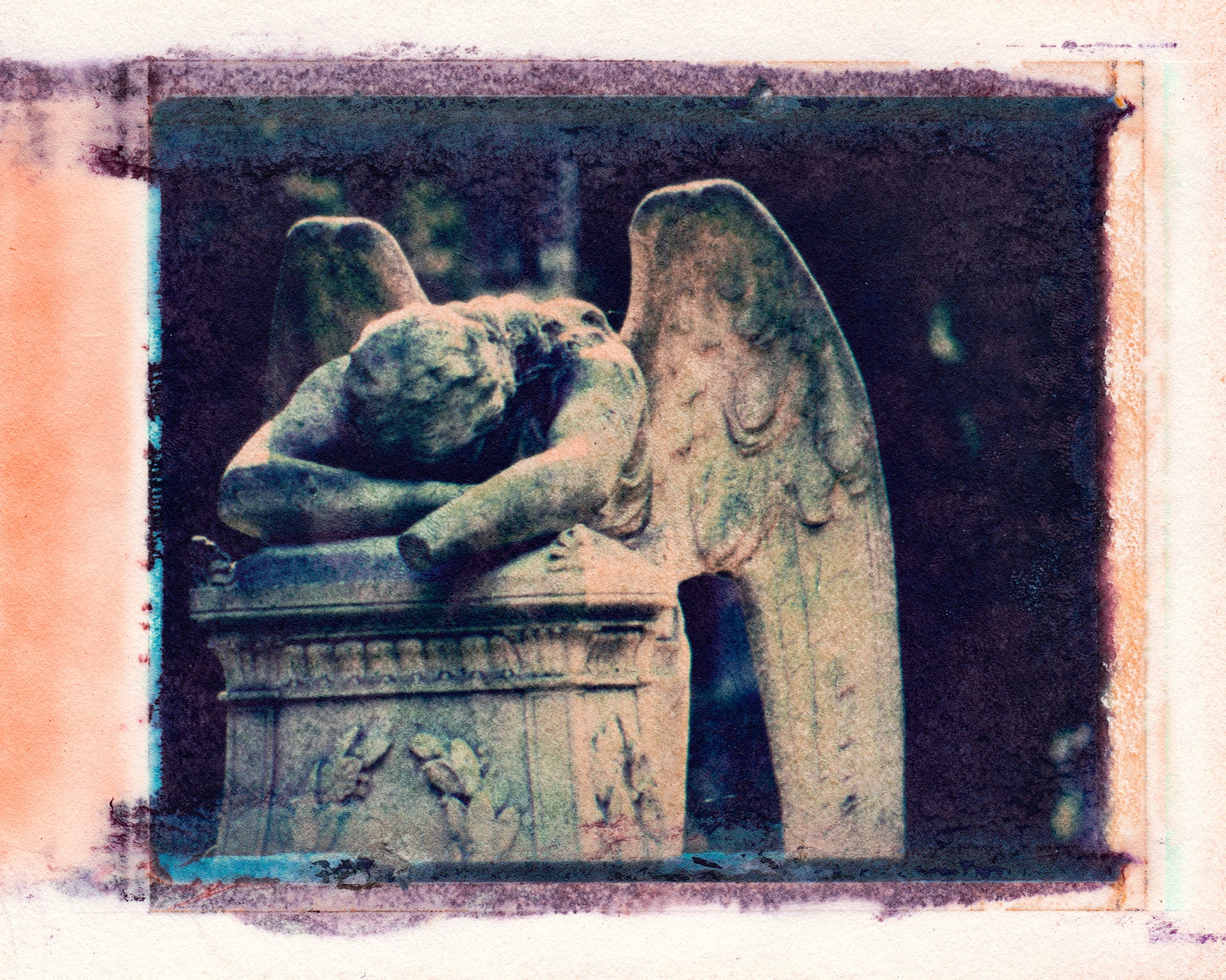 Polaroid transfer of sculpture of angel leaning over a grave, lamenting, in cemetery, angel's left hand has been knocked off