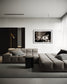 black and white photo of dramatic sky with some clouds and rays of light  in black frame with white matte on white wall in modern living room with gray couches and rug