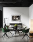 black and white photo of dramatic sky with some clouds and rays of light  in black frame with white matte on white wall in modern breakfast area with green chairs and concrete floors