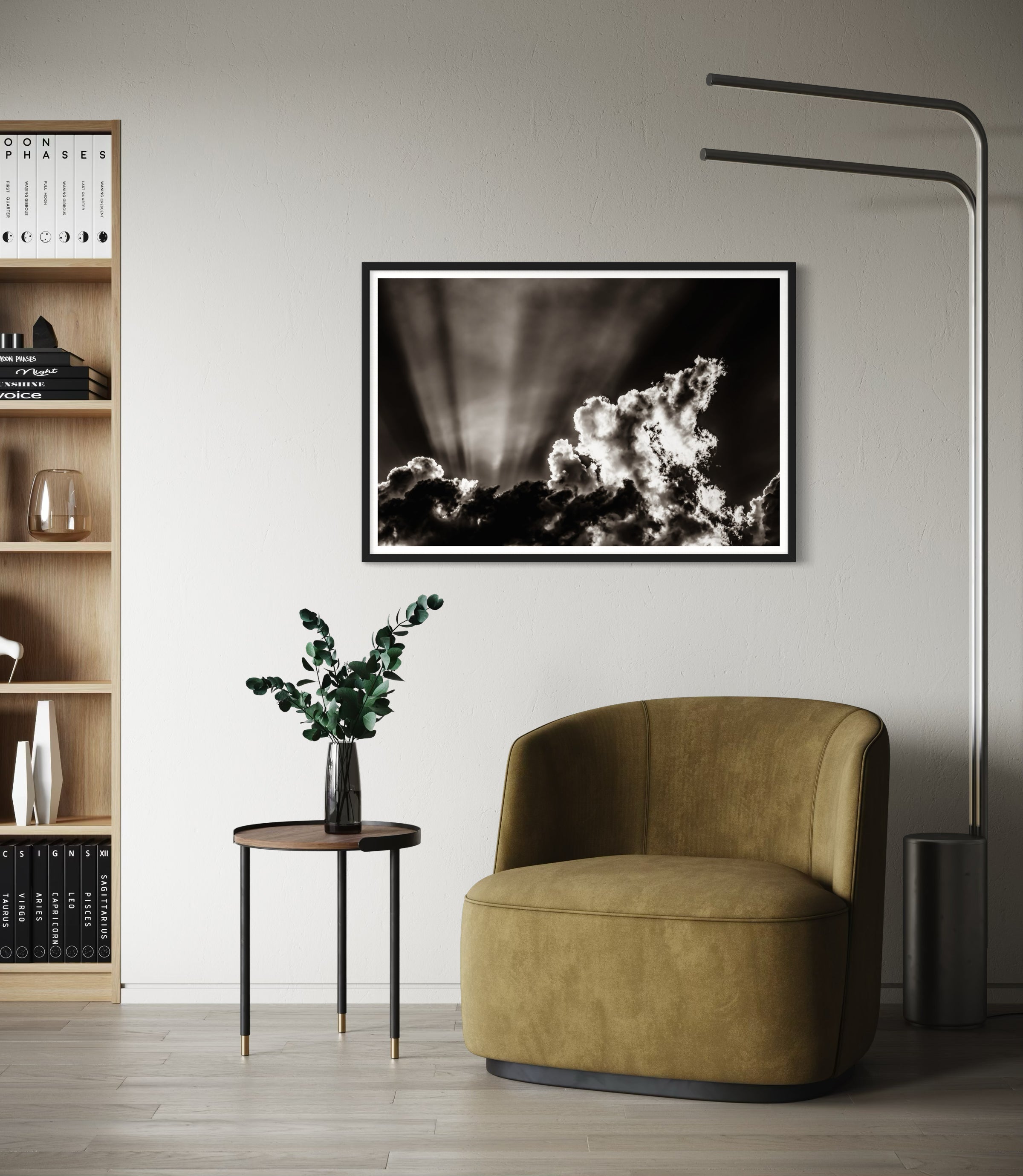 black and white photo of dramatic sky with some clouds and rays of light  in black frame with white matte on light gray wall in modern residential sitting area