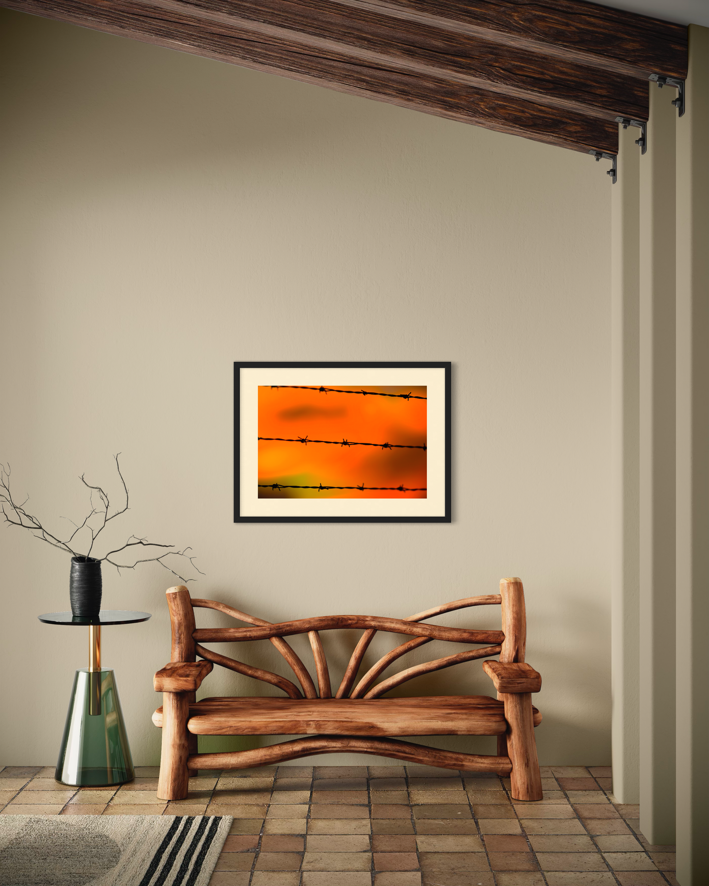 Close up of barbed wire fence with sunset in the background, in black frame on tan wall in rustic living room