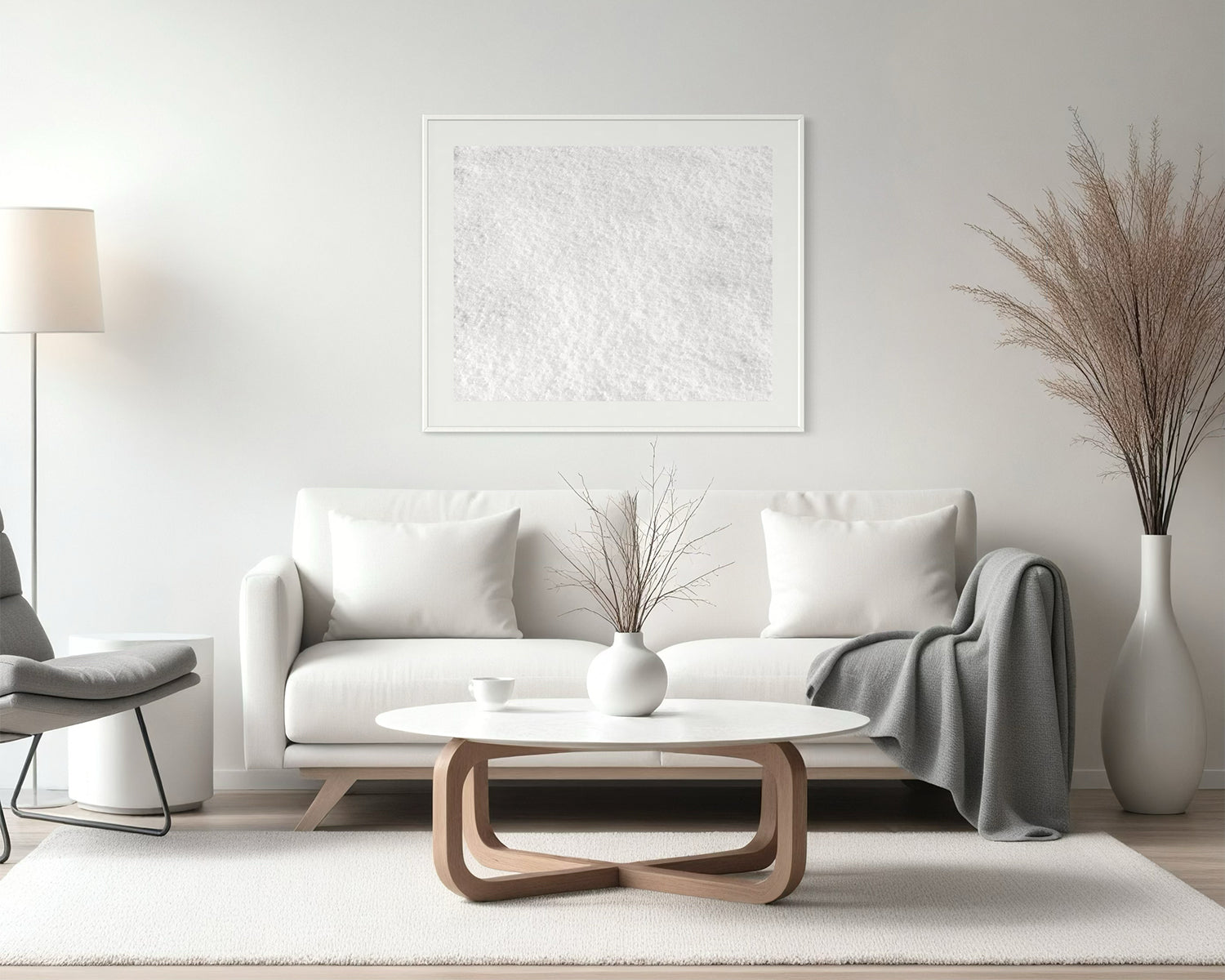 Close up photo of fresh white clean snow in white frame with white matte above white couch in living room with mostly white colors and a little earth tone