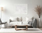 Close up photo of fresh white clean snow in white frame with white matte above white couch in living room with mostly white colors and a little earth tone