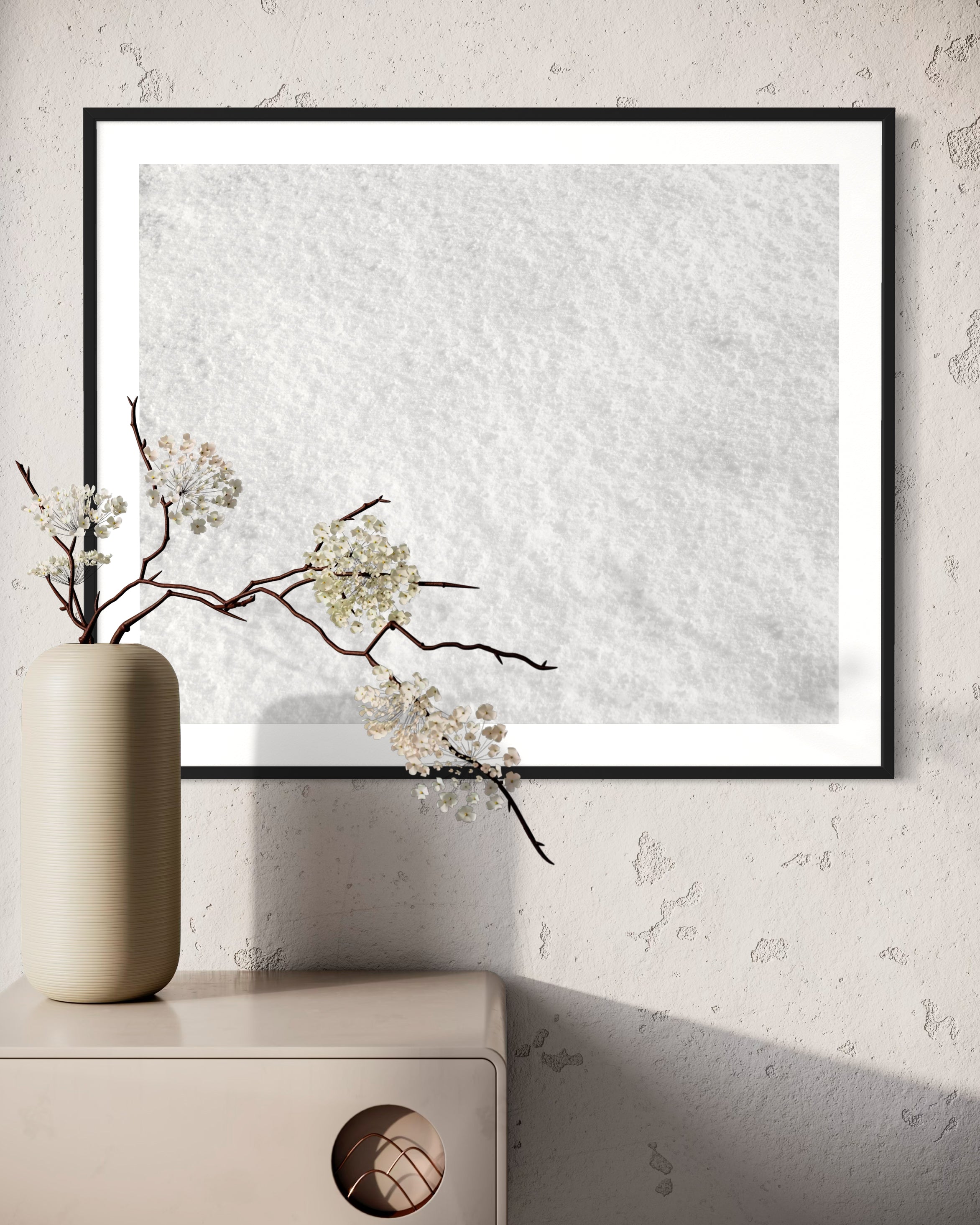 Close up photo of fresh white clean snow in black frame with white matte on old textured concrete wall above small modern table