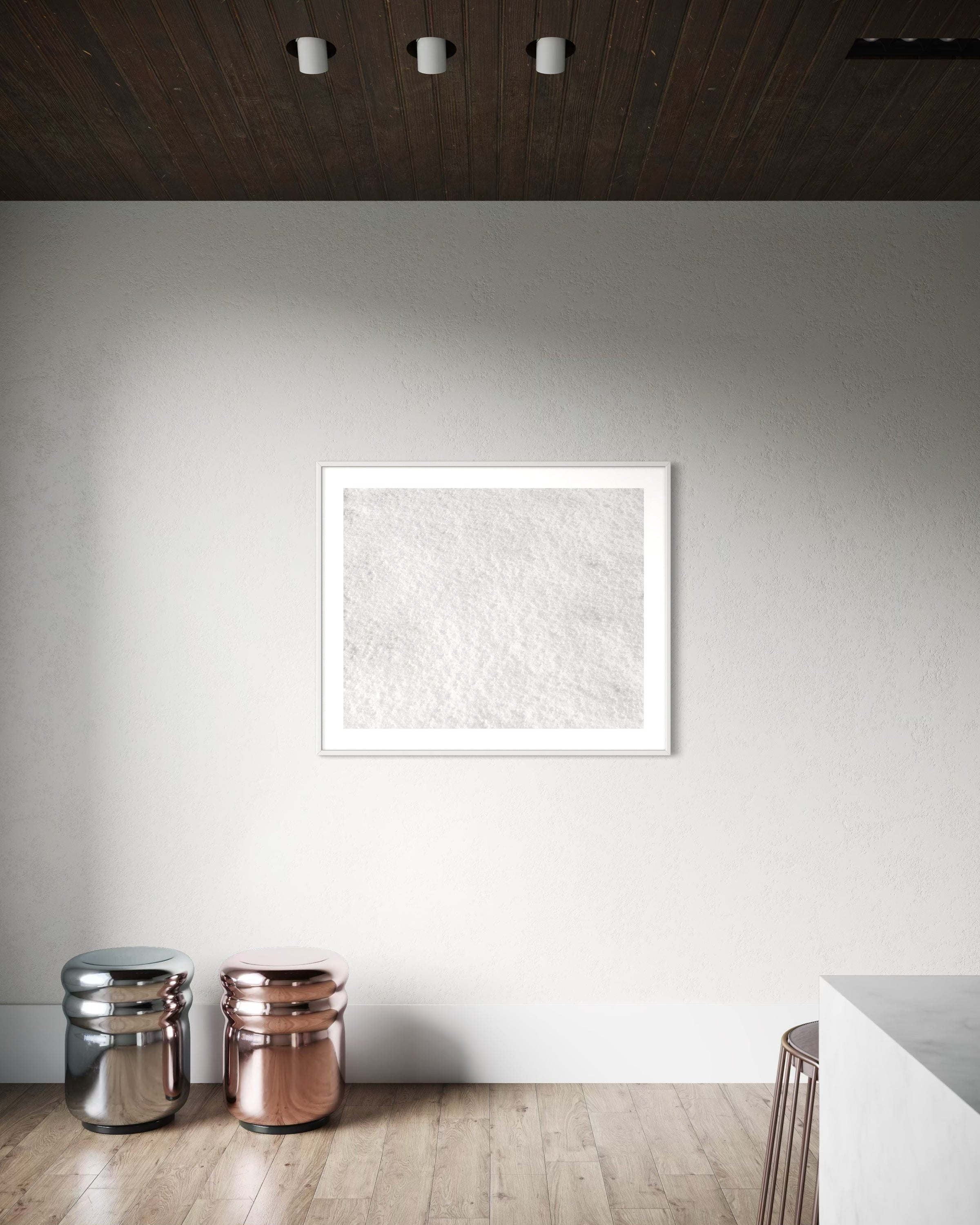 Close up photo of fresh white clean snow in white frame with white matte on white wall in very minimalist area of home with light hardwood floors
