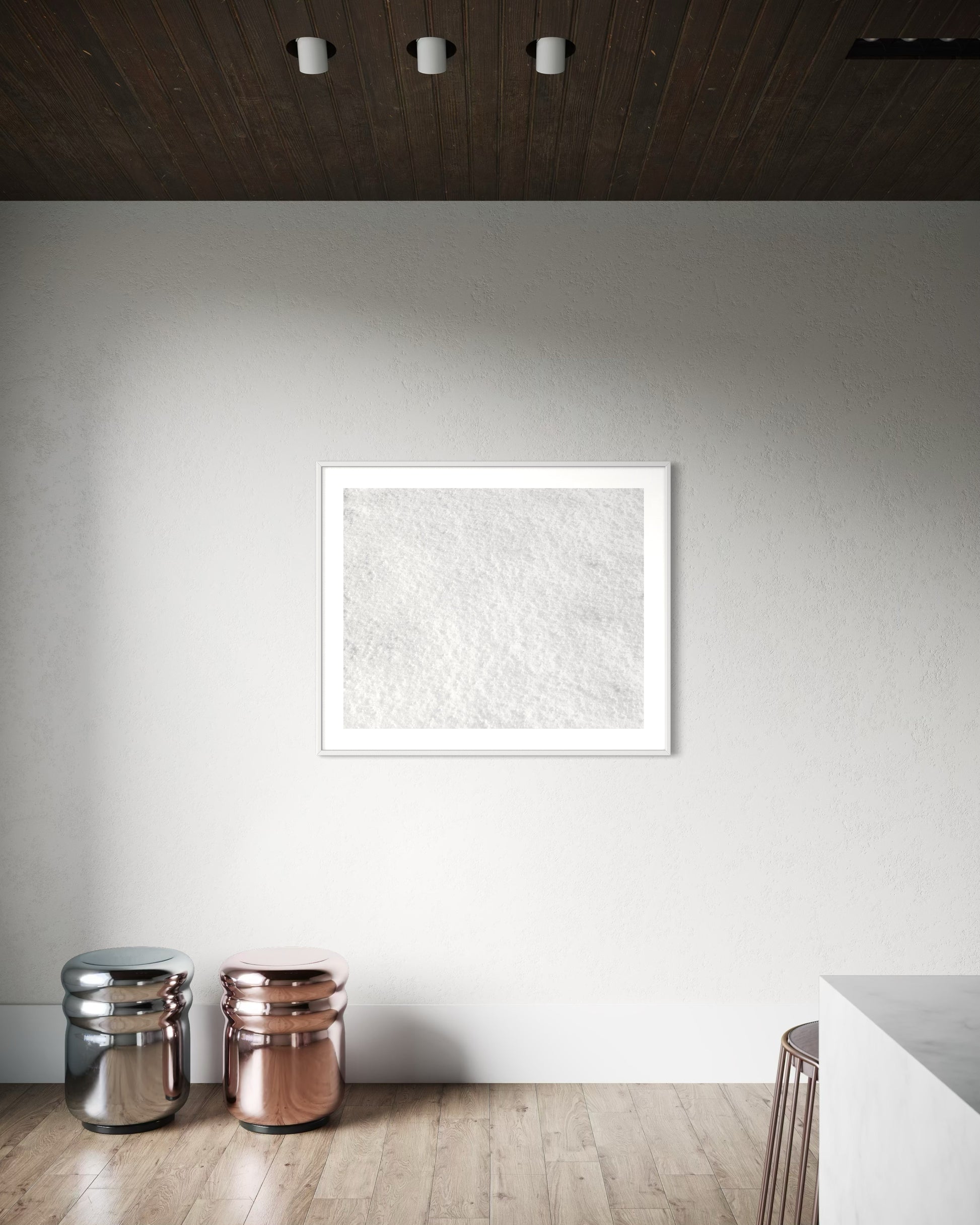 Close up photo of fresh white clean snow in white frame with white matte on white wall in very minimalist area of home with light hardwood floors