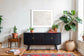 Close up photo of fresh white clean snow in white frame with white matte on above black piece of furniture in country style living room