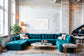 Close up photo of fresh white clean snow in white frame with white matte concrete wall in loft with very large teal couch and baby grand piano.