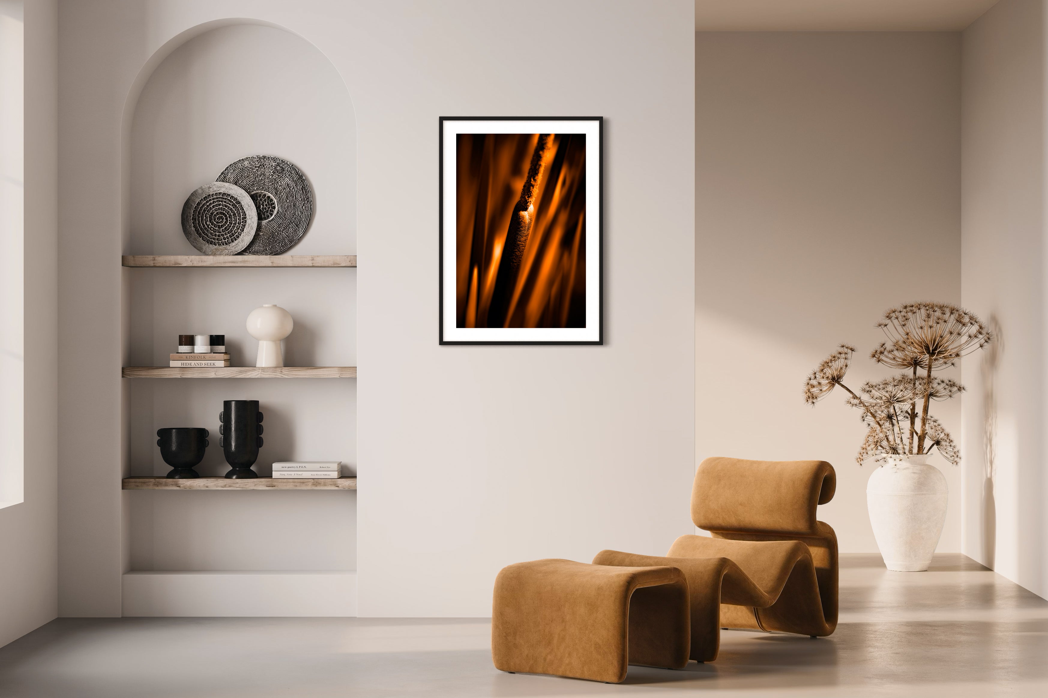 reeds in gold tone with selective focus photo in black frame on tan wall in modern minimalist earthy room with window light
