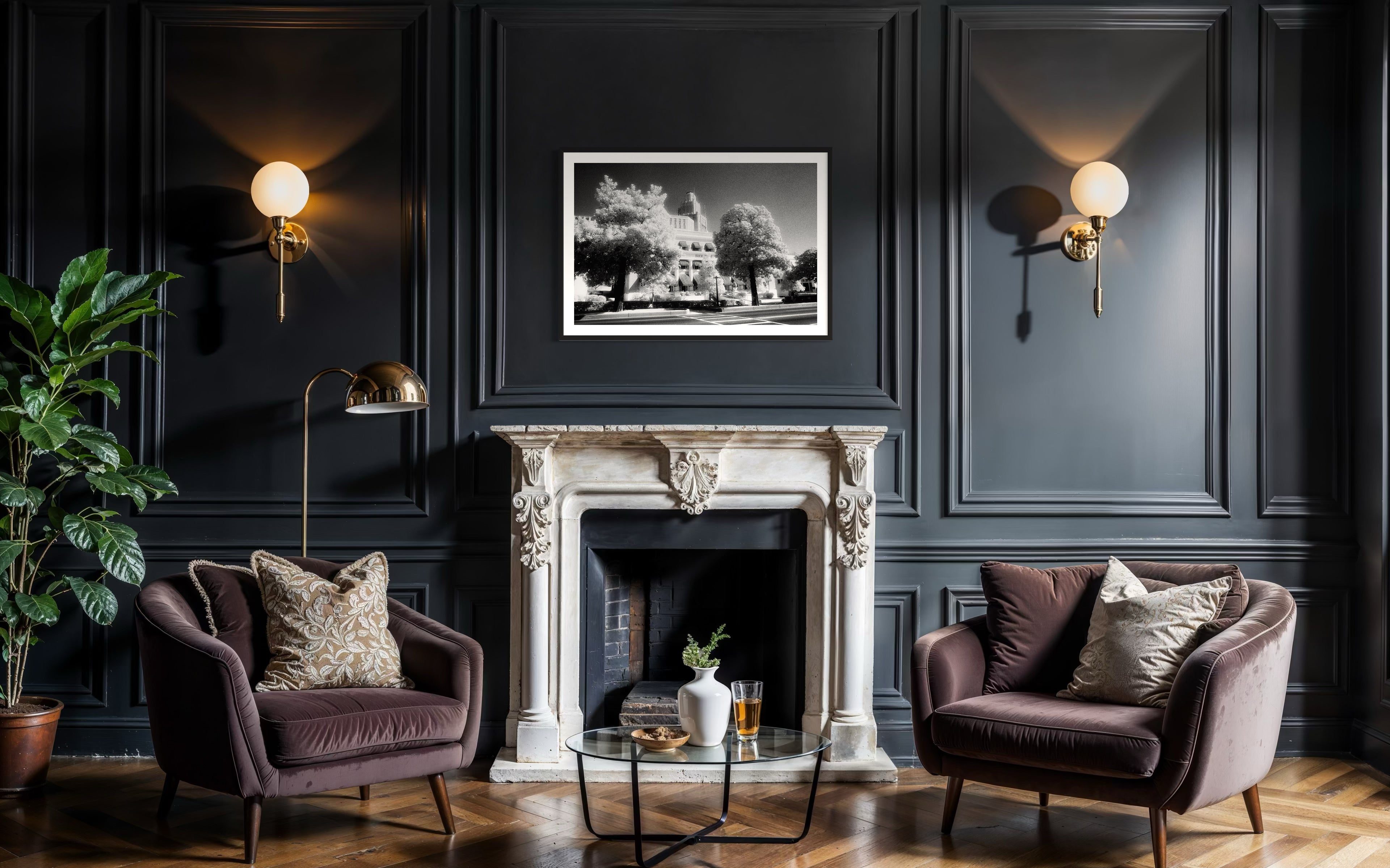 a black and white photo of a building with trees in front in black frame with white matte on dark blue wall in classic living room with hardwood floors