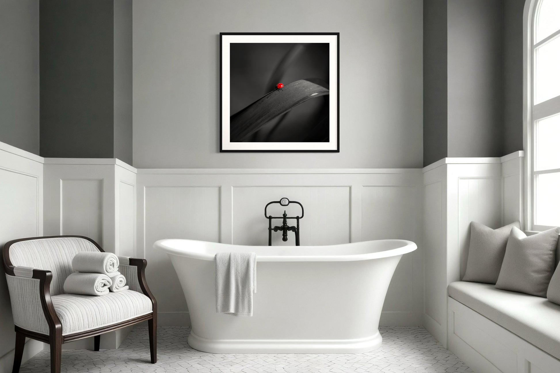 photo of Ladybug in middle of square image, everything except the Ladybug is black and white in black frame on light gray wall in modern bathroom with white and light gray tones