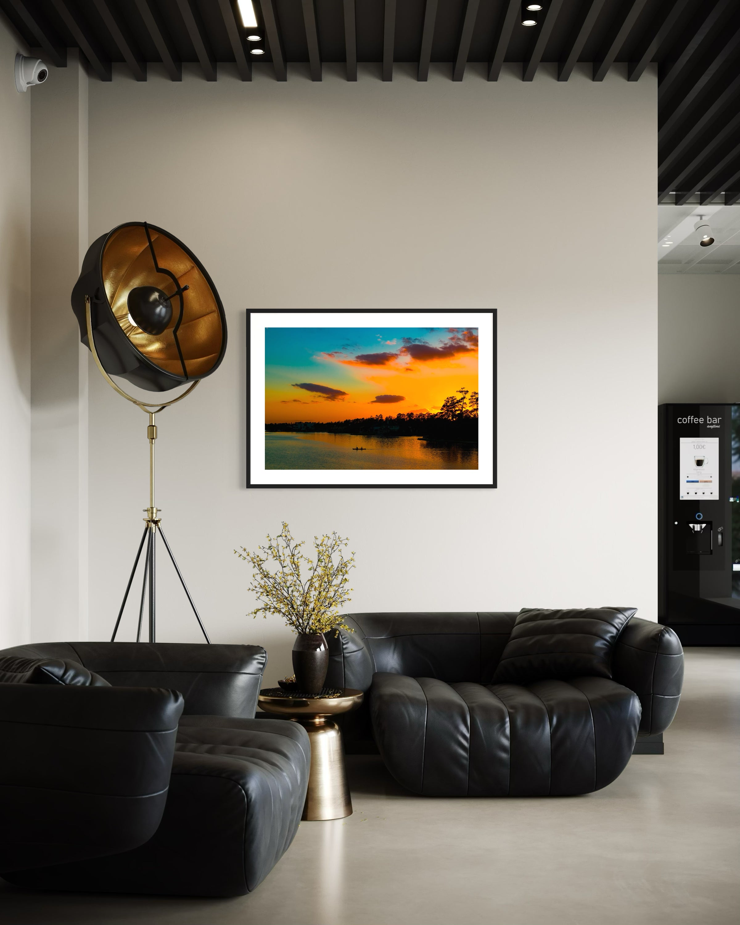 wide angle photo of kayak on lake at sunset in dark blue frame with off white matte on off white wall in modern break area in office