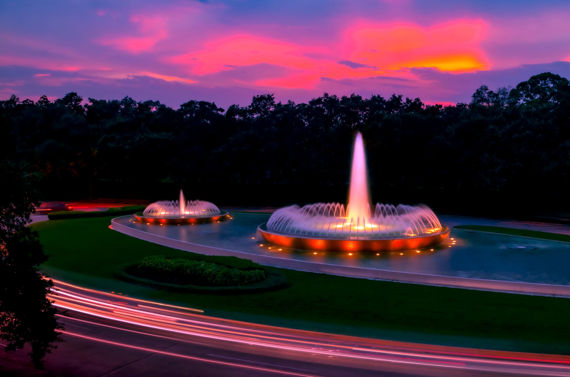 photo of Mecom Fountain in Houston shot at sunset with blurred car lights at the bottom 