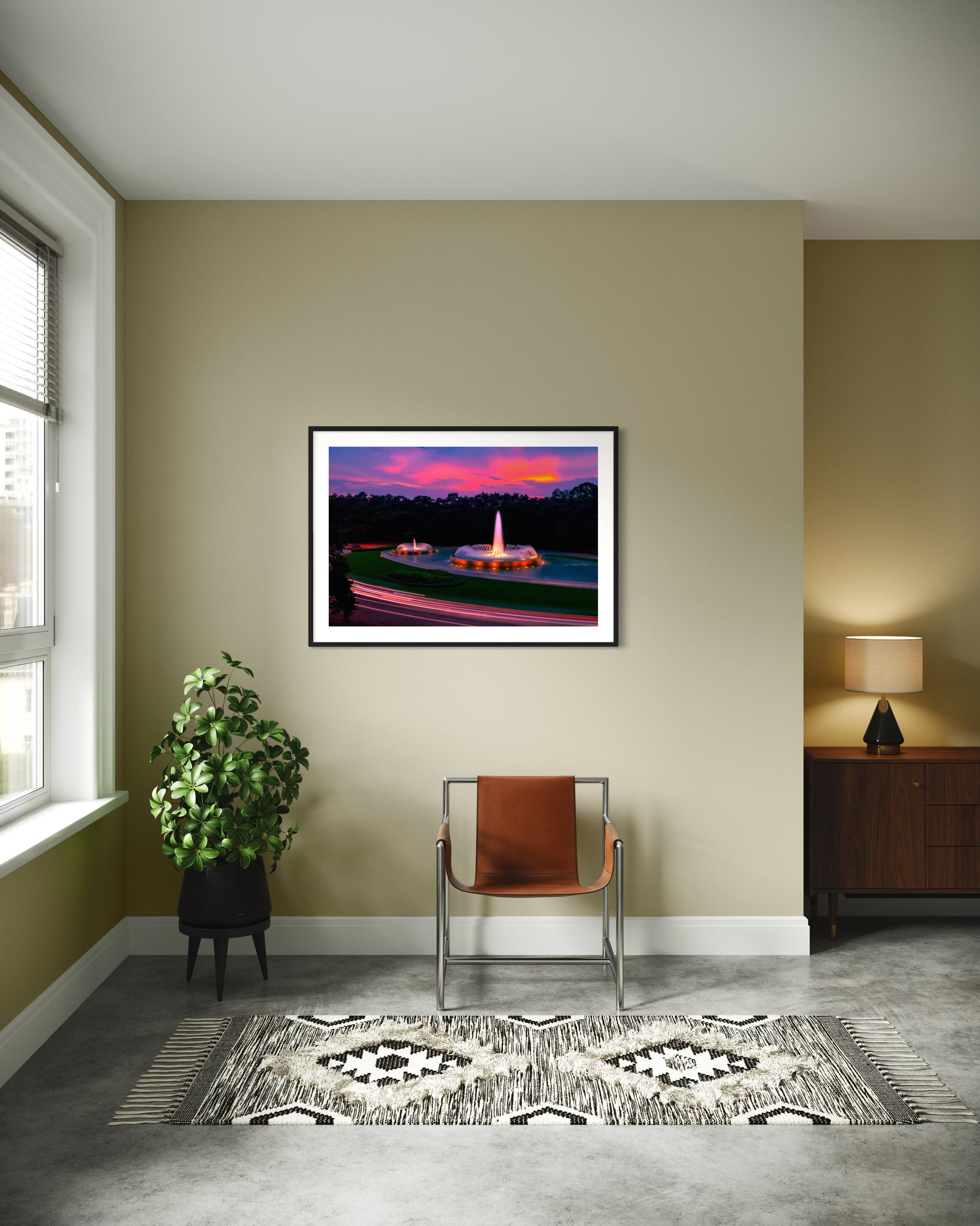 photo of Mecom Fountain in Houston shot at sunset with blurred car lights at the bottom in black frame with white matte on tan wall in modern sitting area with concrete floors and modern furniture