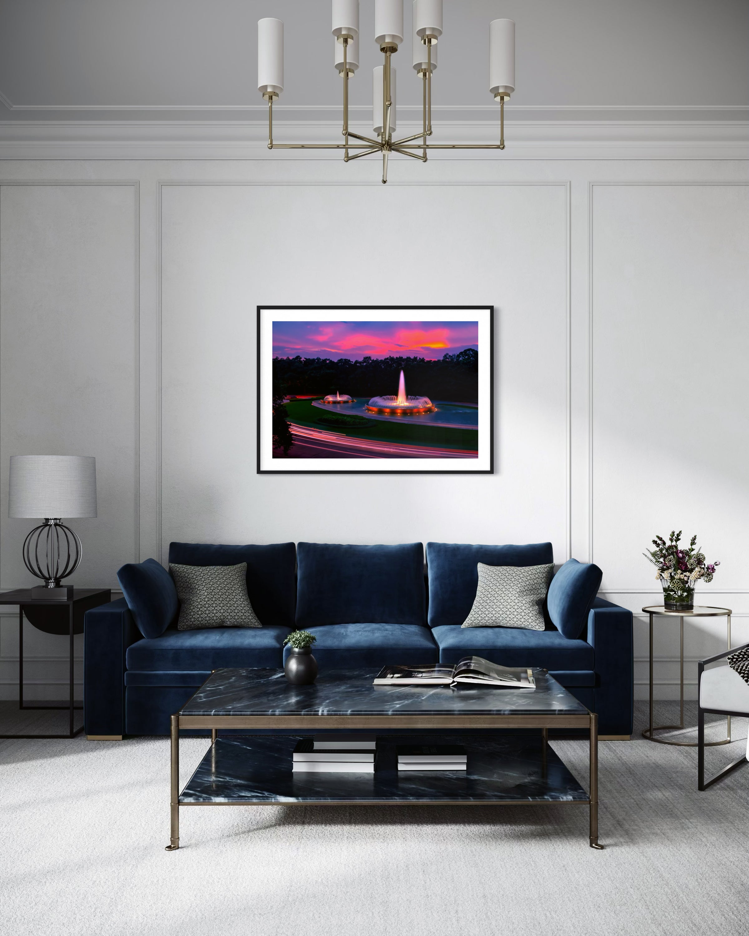photo of Mecom Fountain in Houston shot at sunset with blurred car lights at the bottom in black frame with white matte on white wall above blue couch in modern yet rustic living room with marble coffee table