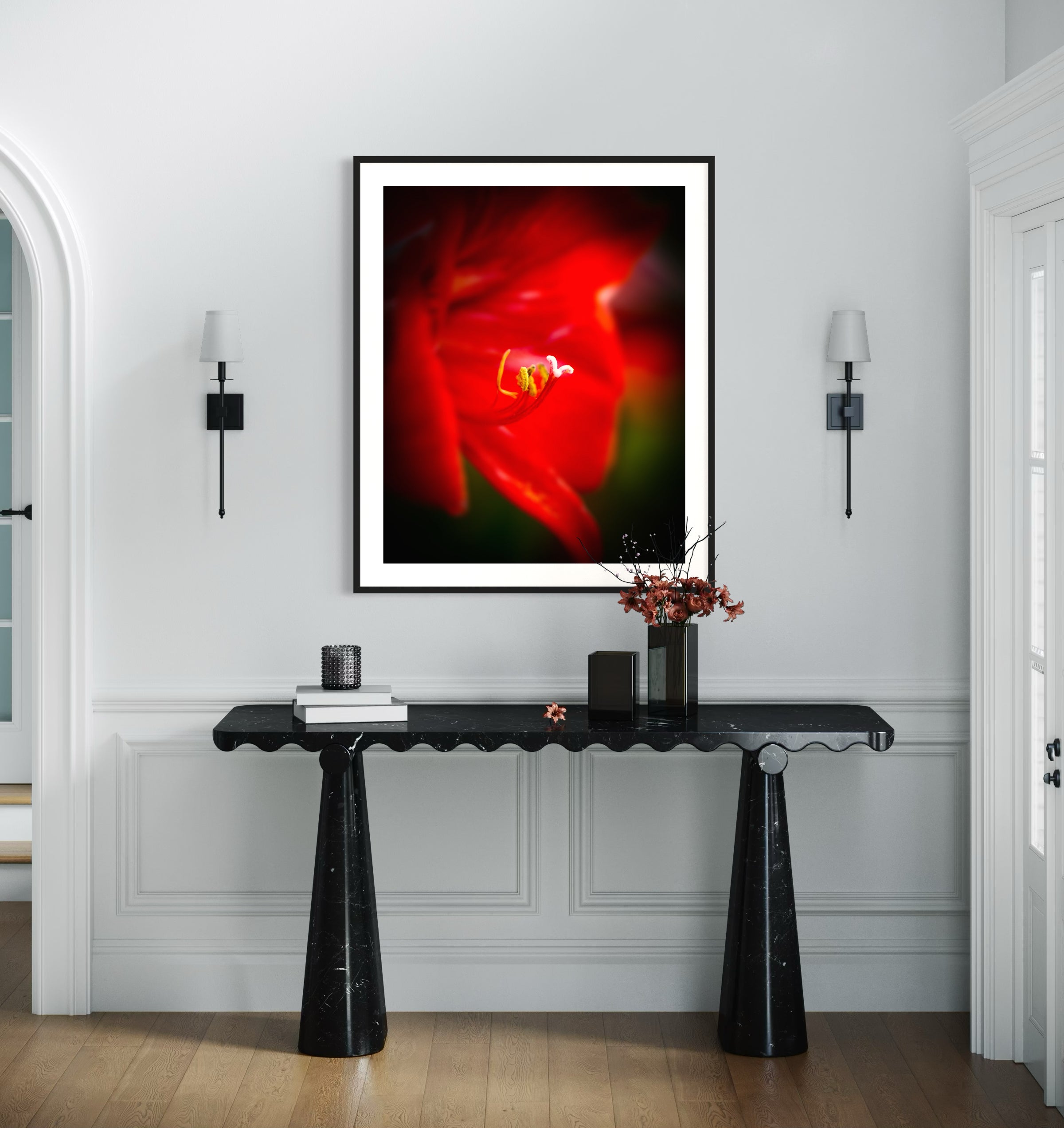 macro photo of red flower, selective focus in black frame on light brown wall above very modern small black table