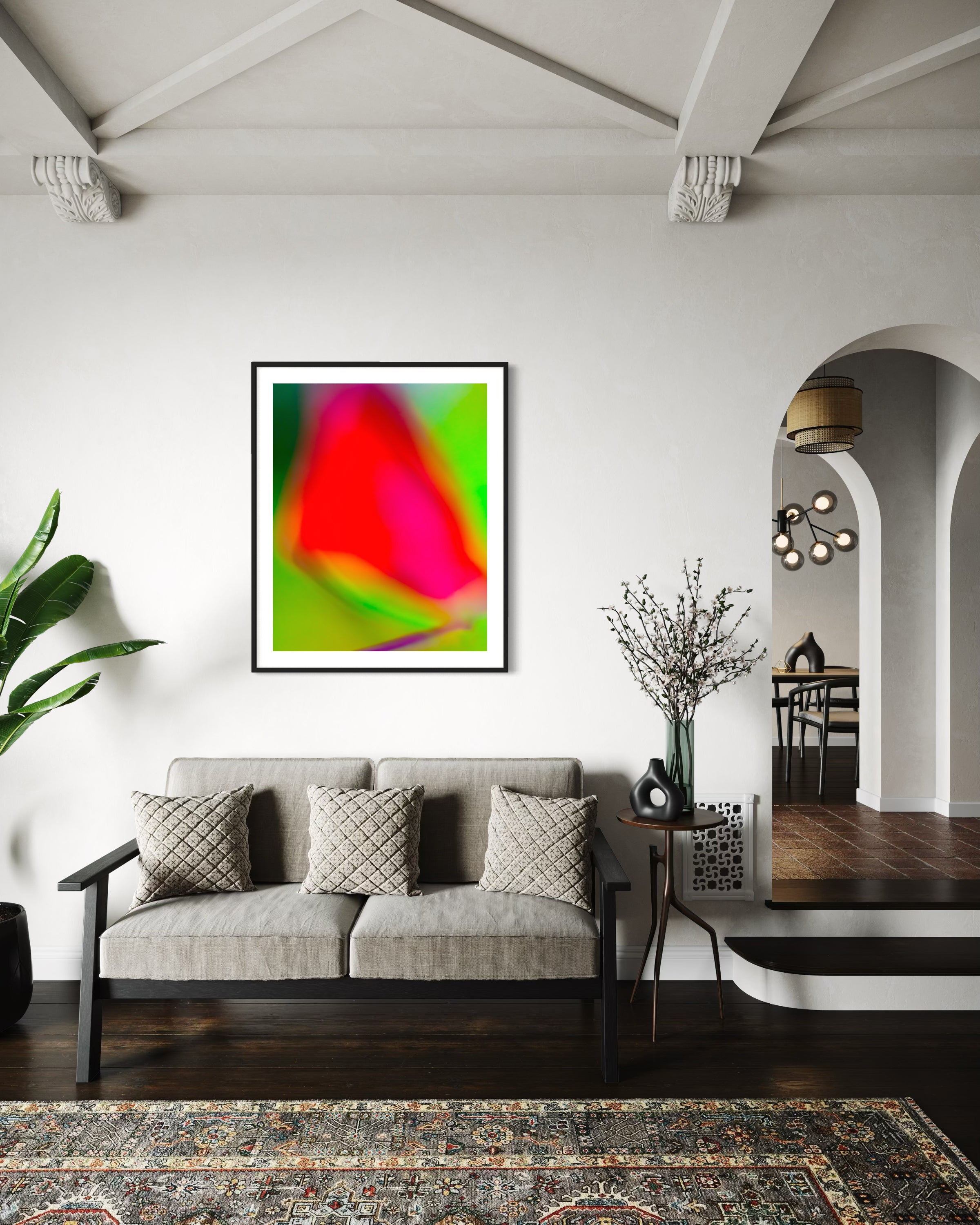 photo of blurry red leaf on blurred bright green background in black frame on white wall in living room with dark tile floors