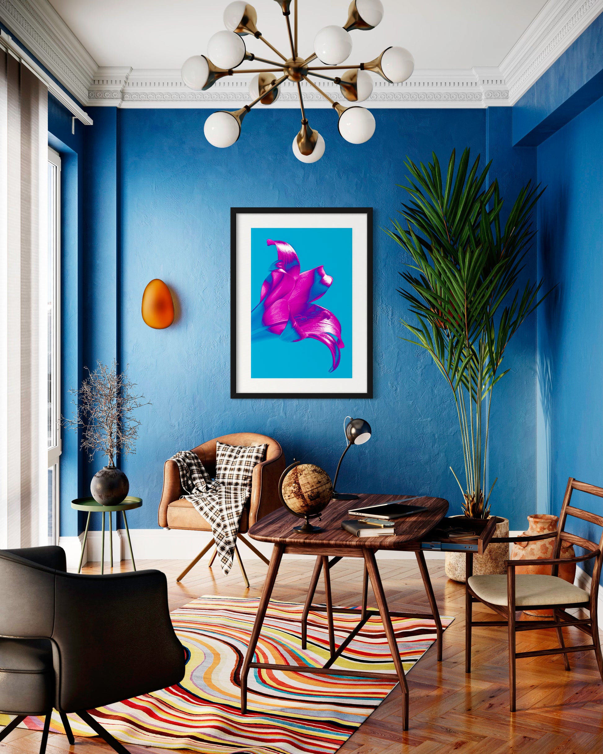 bright pop art photo of pink lily on blue background in black frame in modern room with blue walls