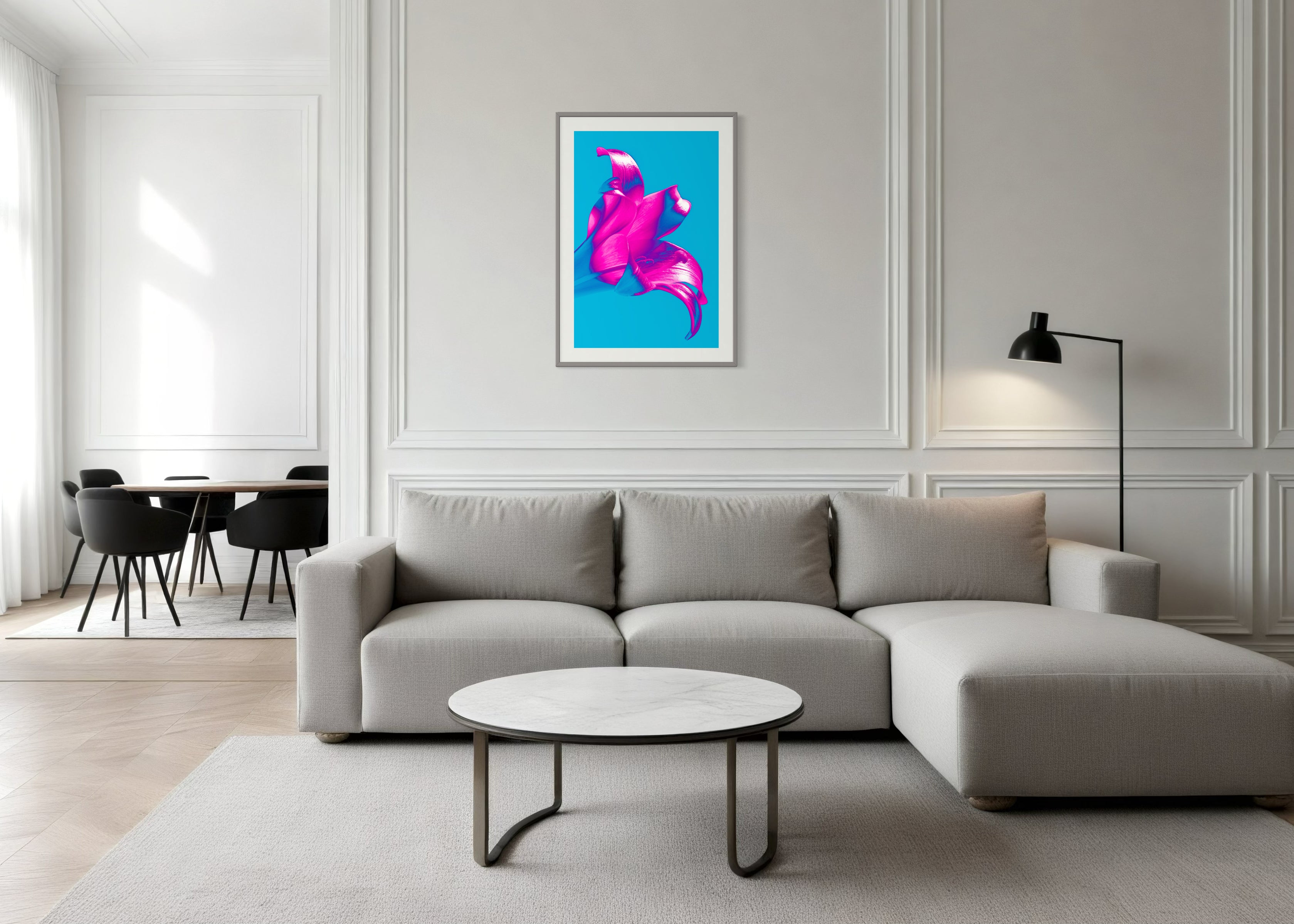 bright pop art photo of pink lily on blue background in gray frame with light gray matte above couch in modern living room with light gray tones