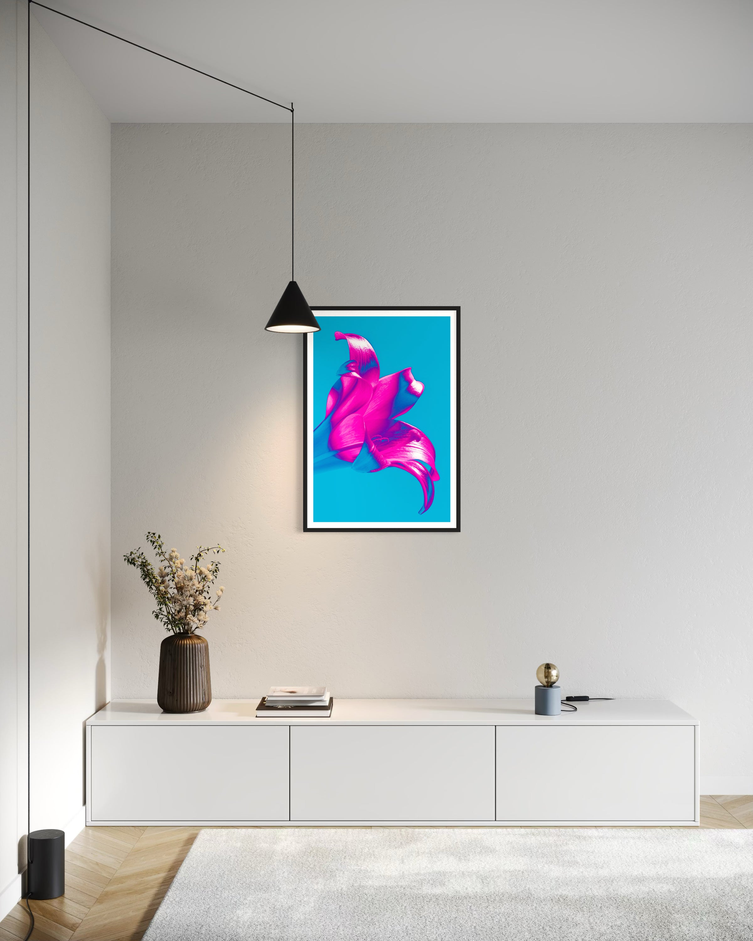 bright pop art photo of pink lily on blue background in black frame with white matte on white wall in minimalist home office space with white walls, furniture and rug on light hardwood floors