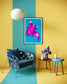 bright pop art photo of pink lily on blue background in black frame with white matte on wall in blue and yellow stripedl sitting room with blue chair room