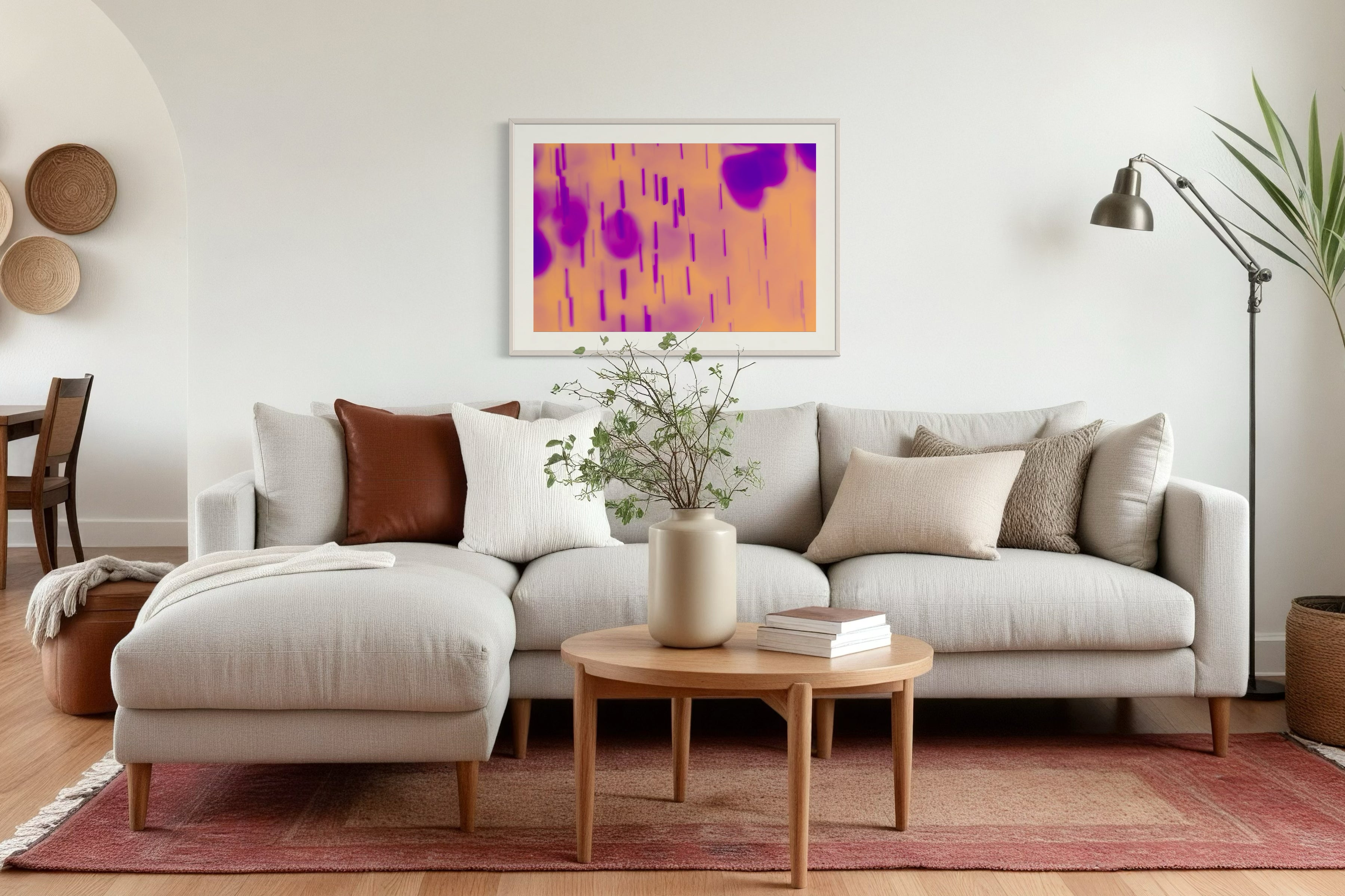 blurred rain in purple on pale yellow background in light gray frame on off white wall in residential seating area with off white couch and hardwood floors