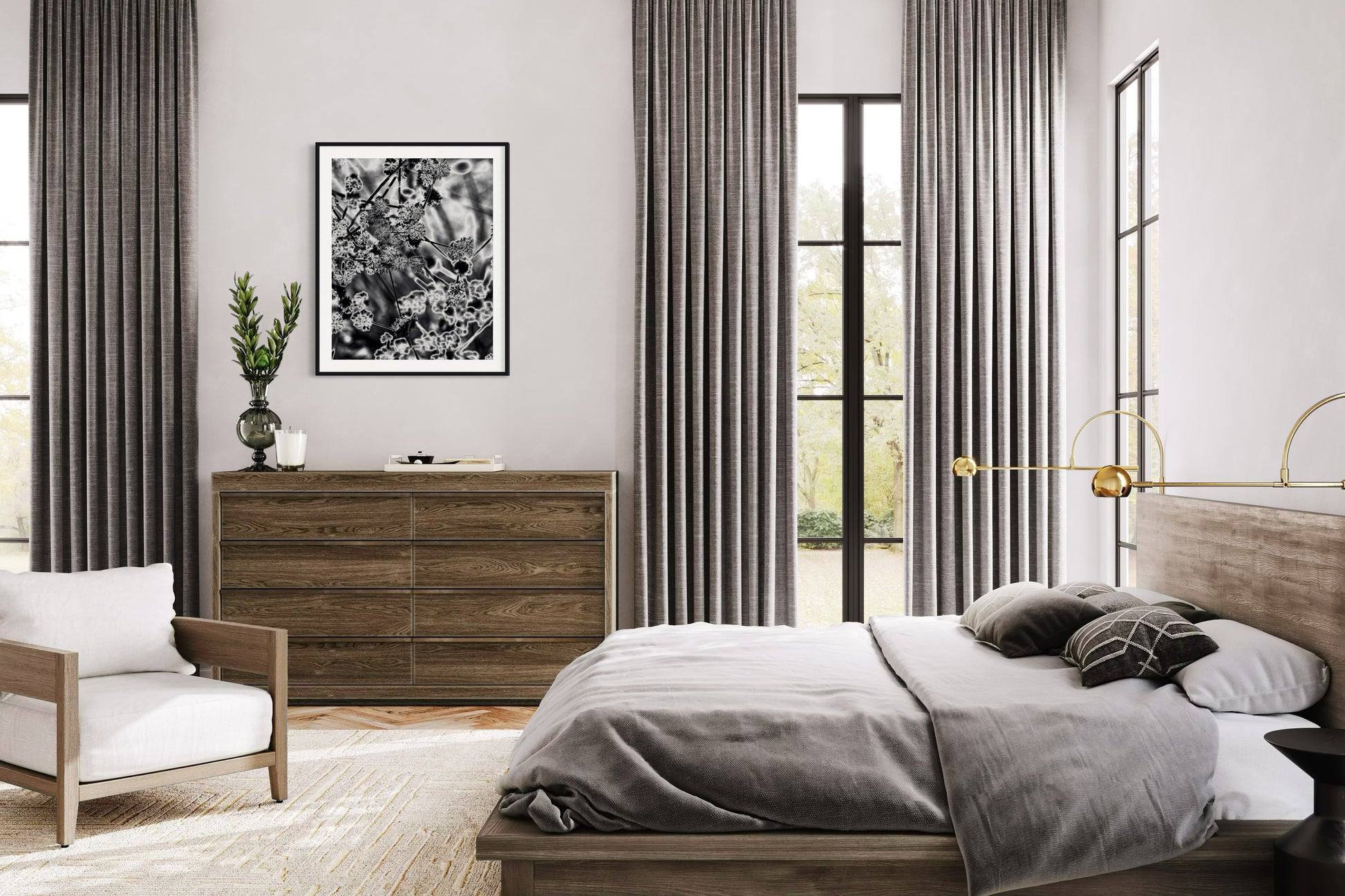 black and white close up of plant with solarized effect in black frame with white matte above small wide wooden piece of furniture with drawers in rustic bedroom