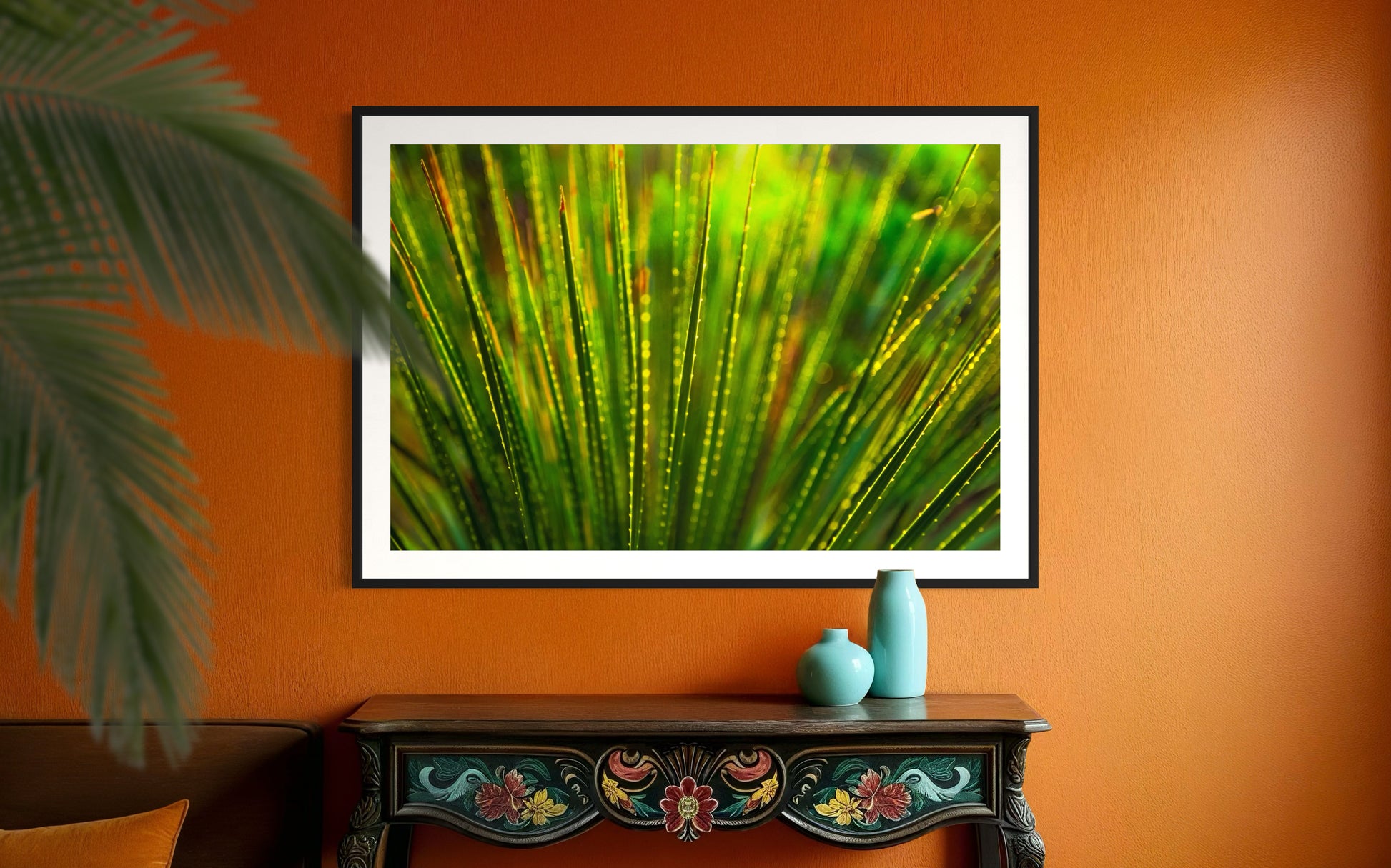photo close up of Sotol plant backlit at dusk in black frame with white matte on orange wall above small black table, large plant on the left