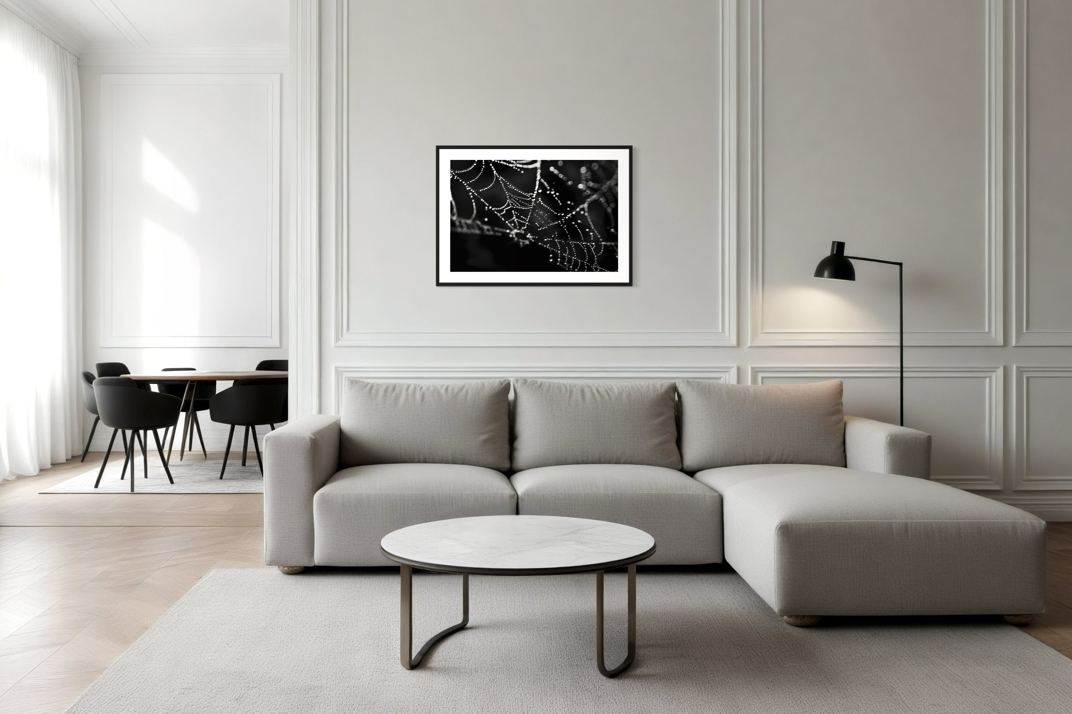 close up photo of rain drops on spider web in black and white in black frame with white matte on white wall in minimalist living room with white and very light gray tones