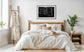 close up photo of rain drops on spider web in black and white in black frame with white matte on white wall in comfortable country style bedroom with  white and earth tones