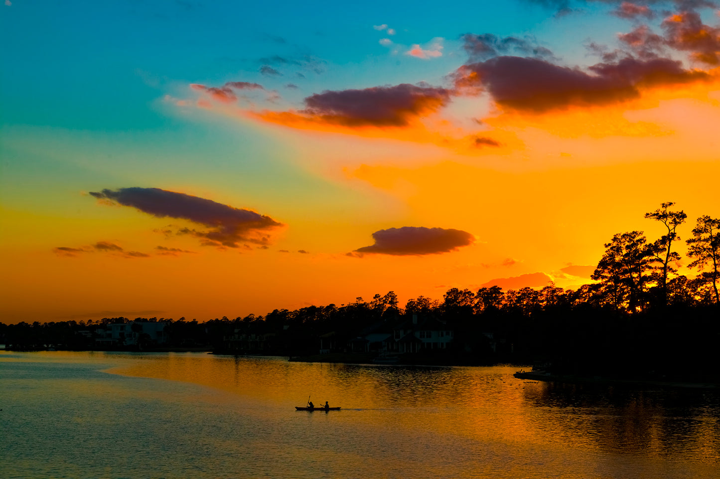 wide angle photo of kayak on lake at sunset