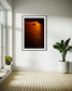 photo of sailboat sailing at sunset, in a very warm tone in black frame with white matte on white wall in corner of minimalist home