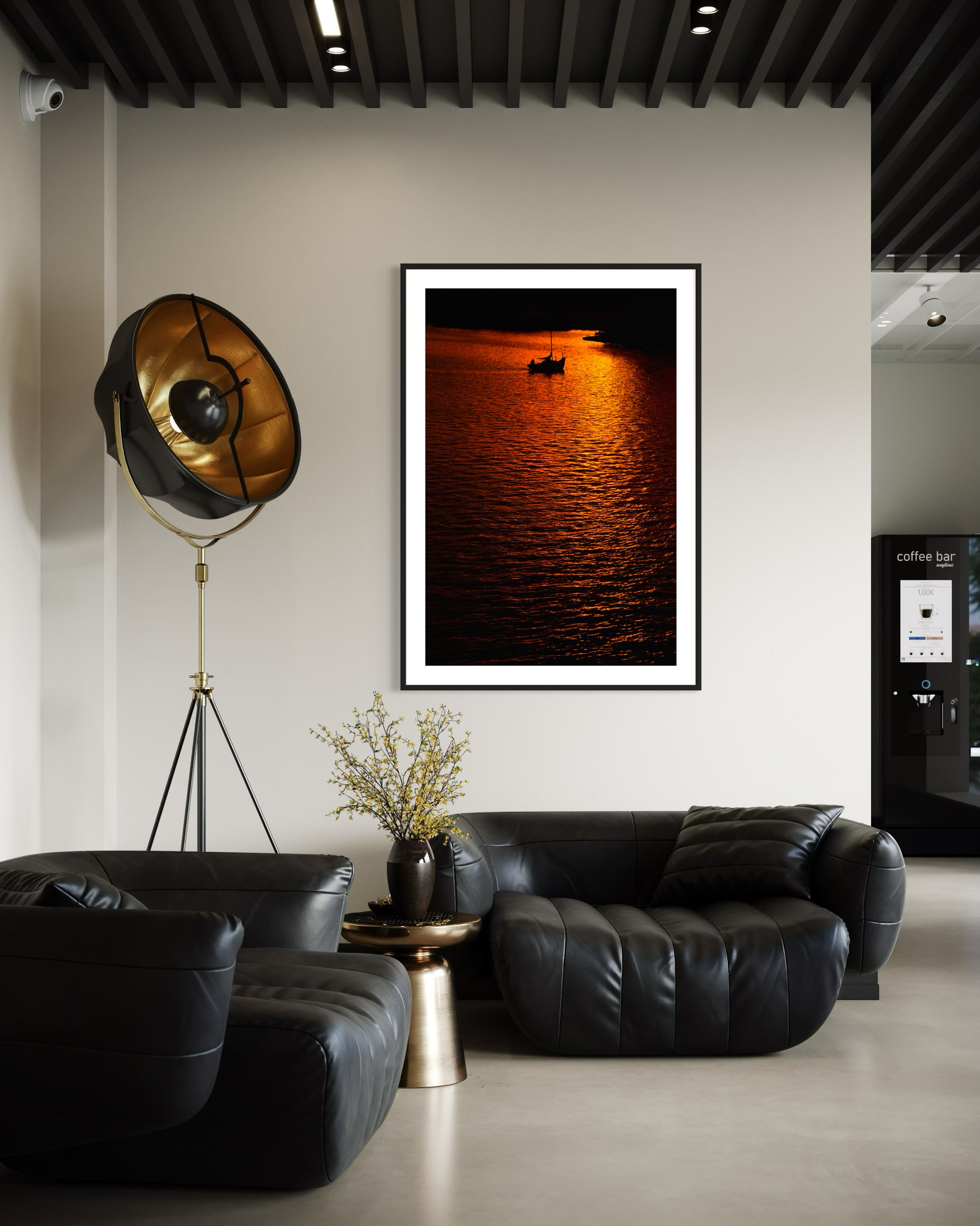 photo of sailboat sailing at sunset, in a very warm tone in black frame with white matte on white wall above couch in modern office break room