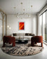 orange abstract with upward motion in black frame with white matte on off white wall in small modern living room with gray couch and two orange chairs on round abstract rug