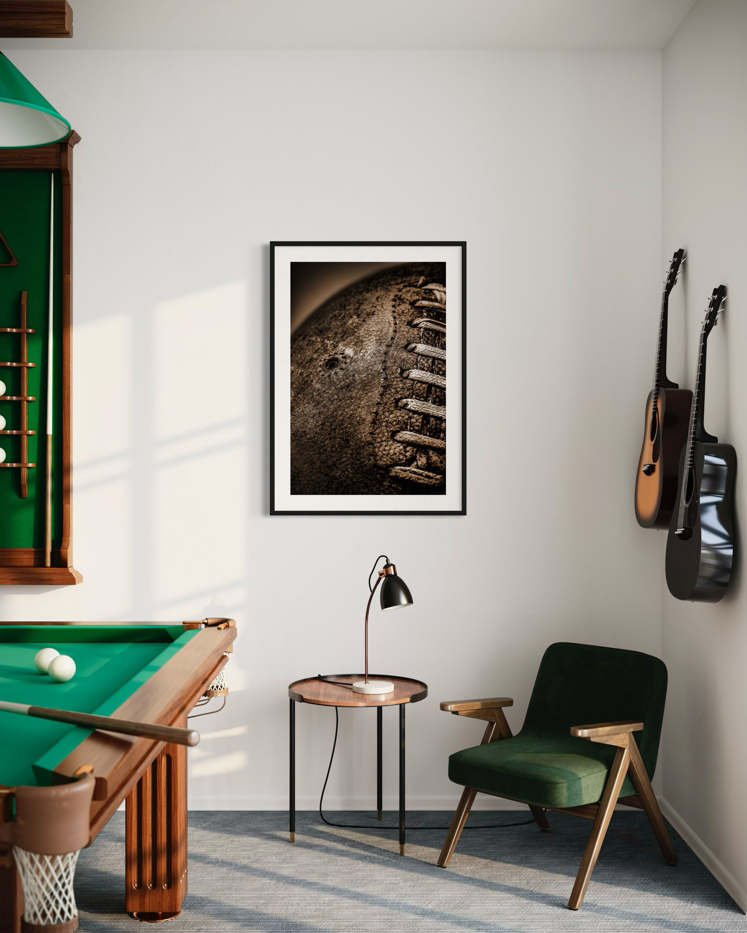 Sepia tone old football close up with a grungy look shot in studio in black frame with white matte on white wall in game room with pool table and guitars on the wall