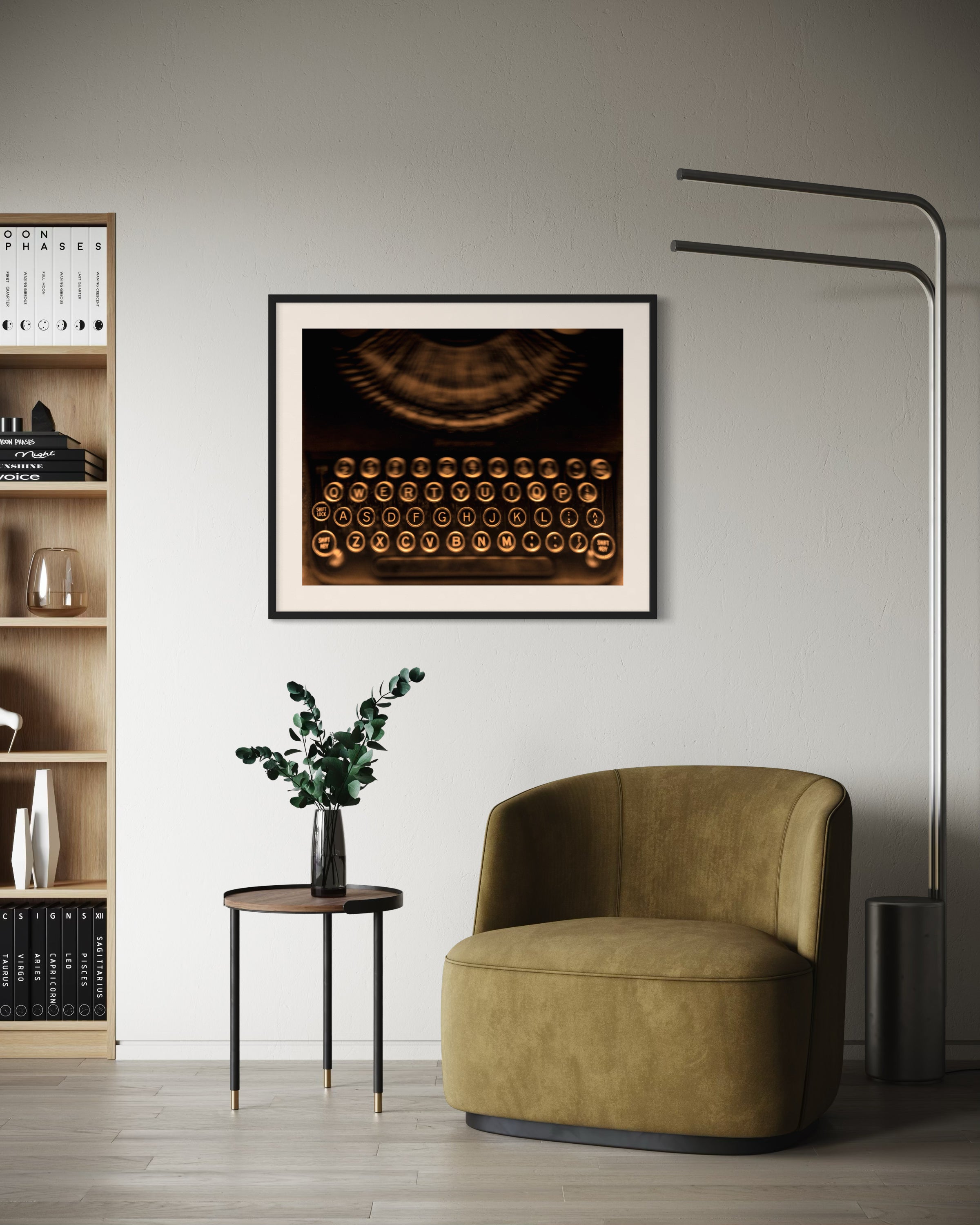 close up of old typewriter from above, horizontal black and white photo in black frame with white matte on off white wall in residential modern sitting area