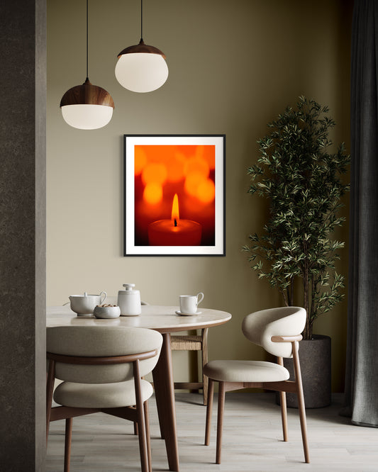 close up photo of single candle with other candles out of focus in the background in black frame on wall in modern kitchen