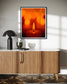 close up photo of single candle with other candles out of focus in the background in black frame with white matte on tan wall above modern furniture with white top and wooden base with sliding doors