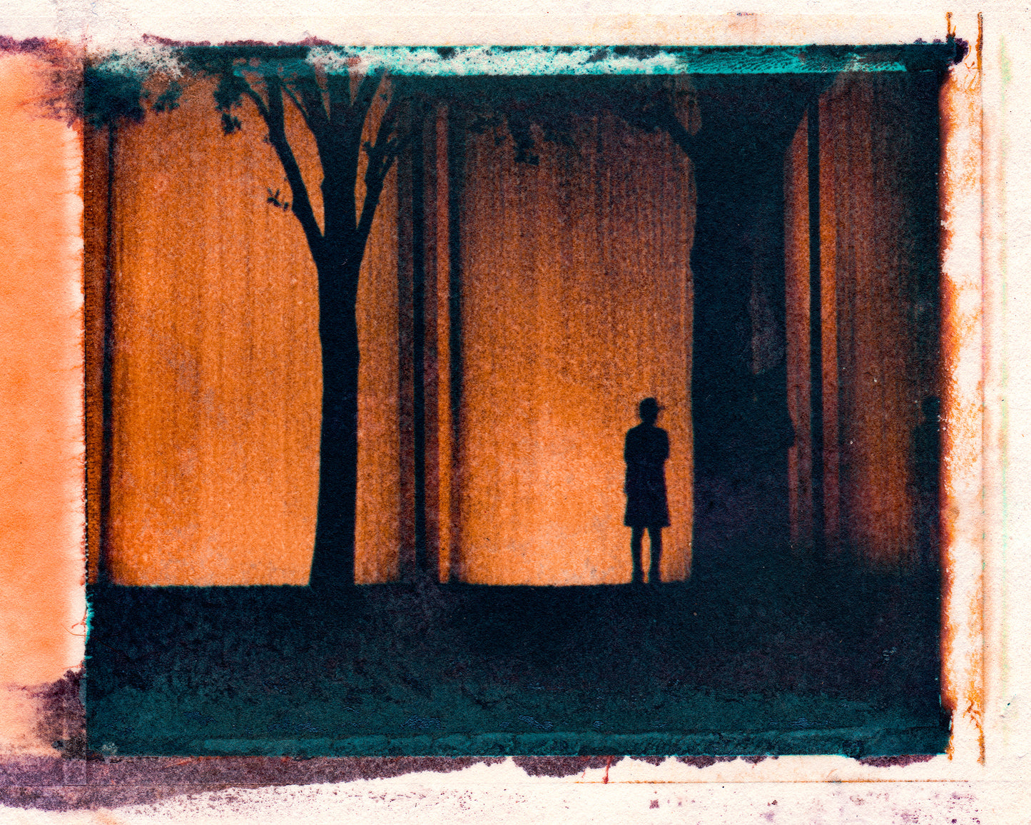 Polaroid transfer of silhouette  of man and two trees with city waterfall in the background