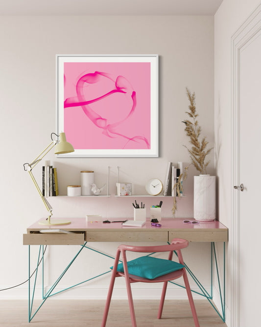 Modern home office with a pink abstract art piece on the wall, a desk, and chair.