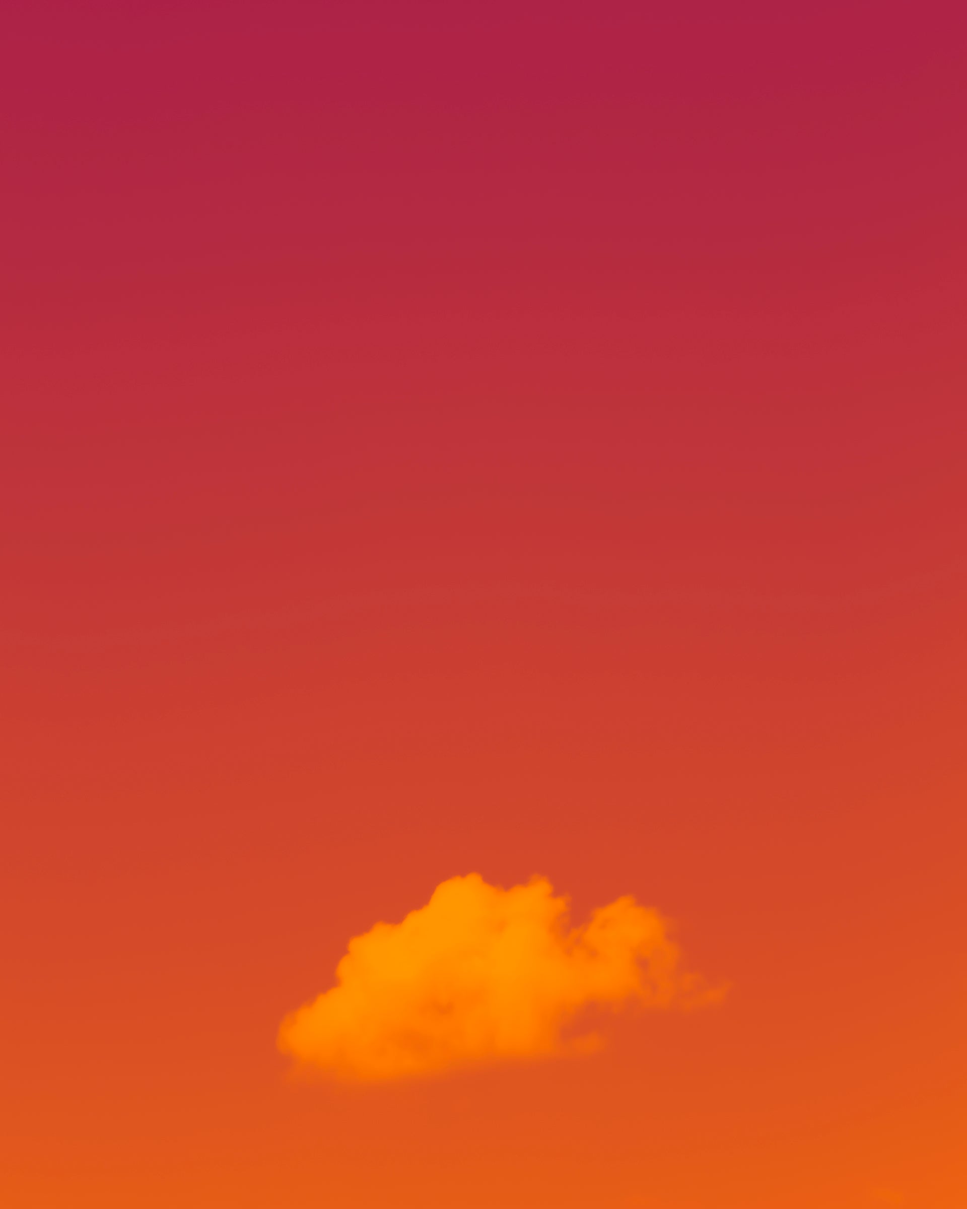 photo of single cloud, orange and magenta background