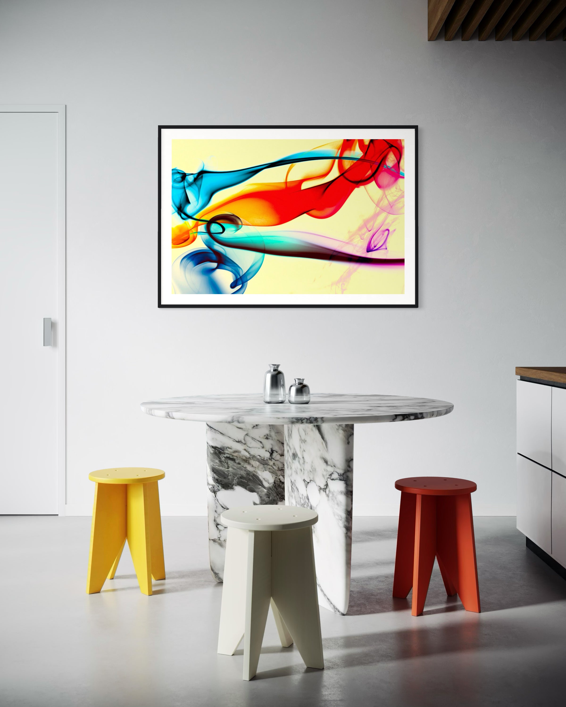 swirls of blue, yellow, orange, teal, purple and red on light yellow background in black frame with off white matte on light gray wall in modern kitchen