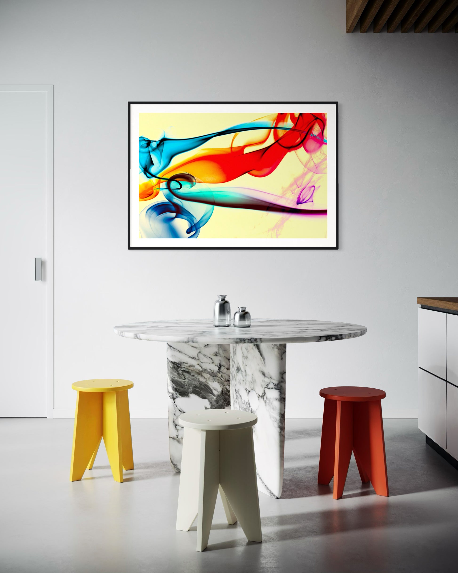 swirls of blue, yellow, orange, teal, purple and red on light yellow background in black frame with off white matte on light gray wall in modern kitchen