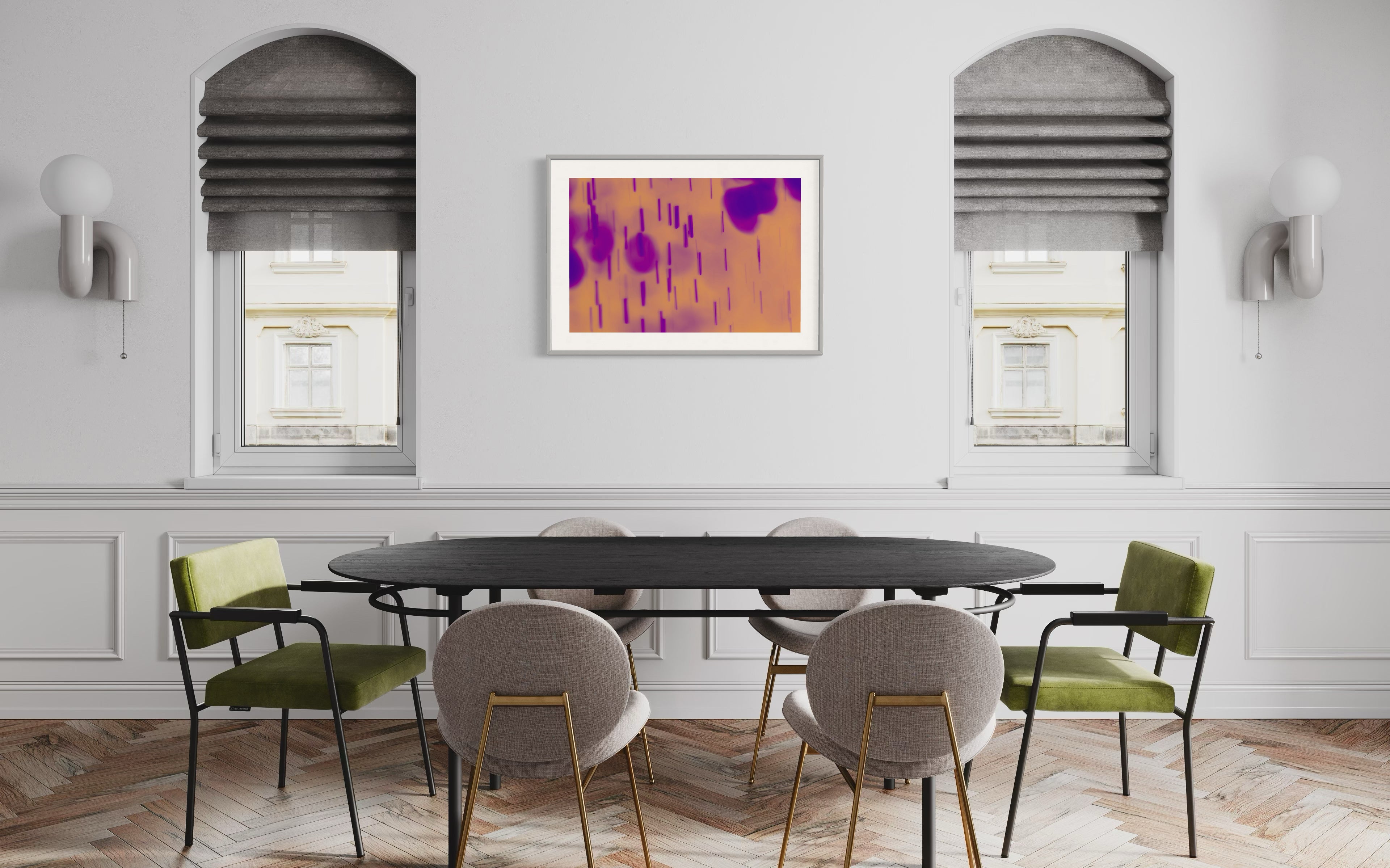 Modern dining room with a round table and chairs, featuring abstract art on the wall.